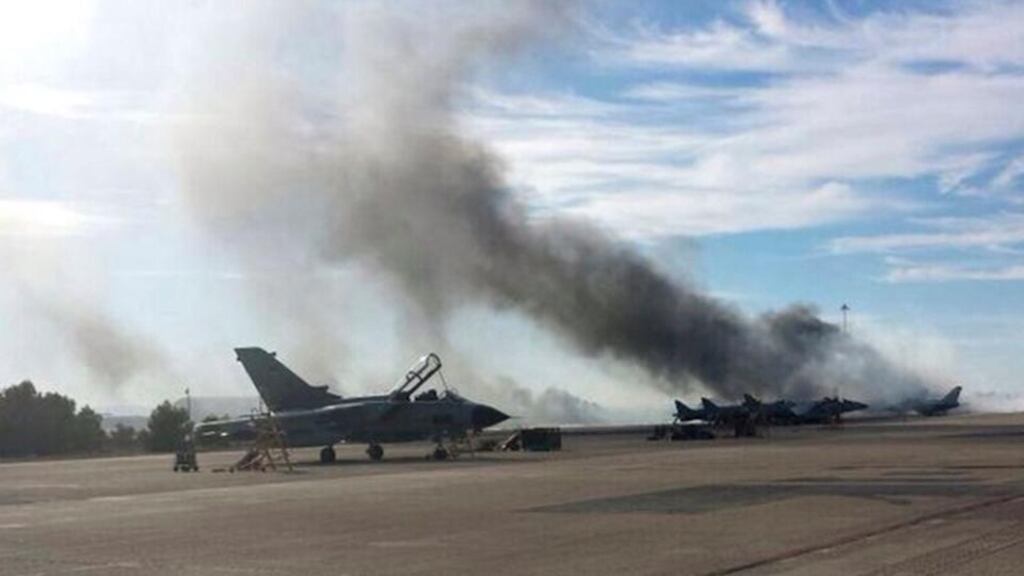 Smoke rises from Los Llanos military base after a Greek fighter jet crashed during a Nato exercise near Albacete. Photograph: Cadena Ser/Reuters.