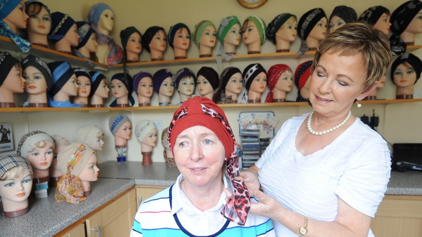 Ursula Hanley adjusting a head cover for a woman in her showroom in Athlone, Co Westmeath. Photograph: James Flynn/APX