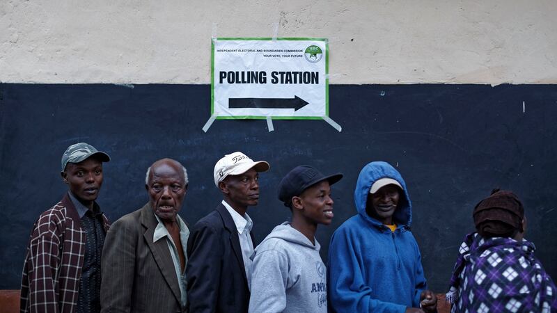 Kenyans queue to vote just after dawn in president Uhuru Kenyatta’s hometown of Gatundu, Kenya. Photograph: Ben Curtis/PA