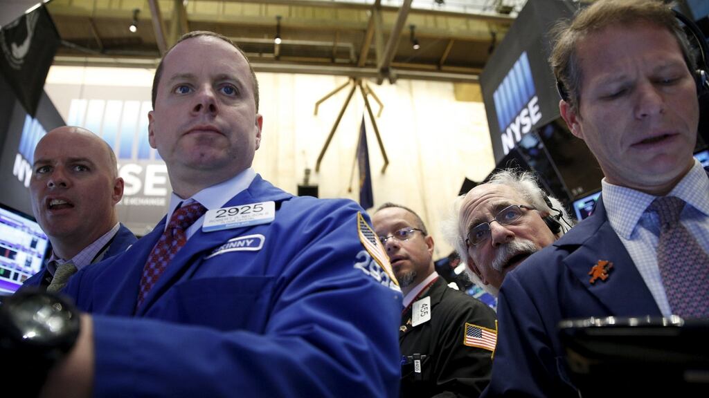 Traders work on the floor of the New York Stock Exchange. The Dow Jones industrial average was up 15.9 points, or 0.09 percent, at 17,540.81 in morning trading; the S&P 500 was up 4.66 points, or 0.23 per cent, at 2,048.07 and the Nasdaq Composite index was up 10.36 points, or 0.21 per cent, at 5,005.72. Photograph: Brendan McDermid/Reuters