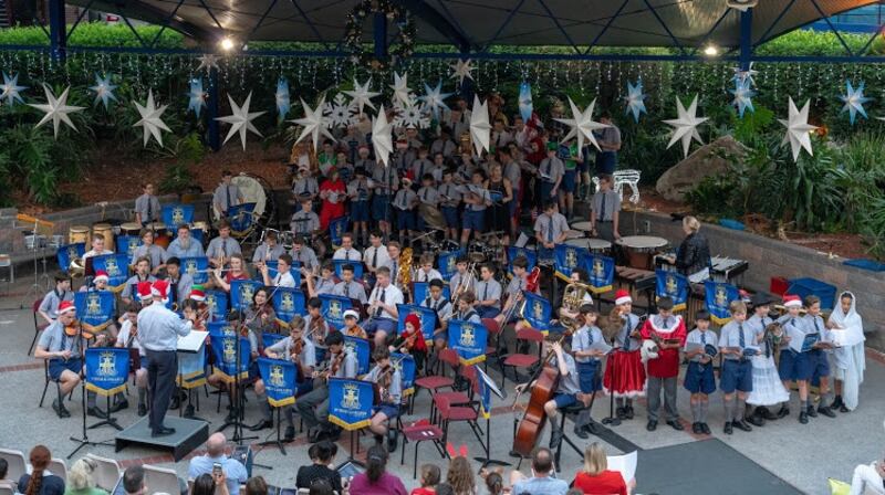‘The schoolyard festooned with glittering cardboard stars, LED-lit reindeers and giant plastic snowflakes twinkling from the outdoor stage.’