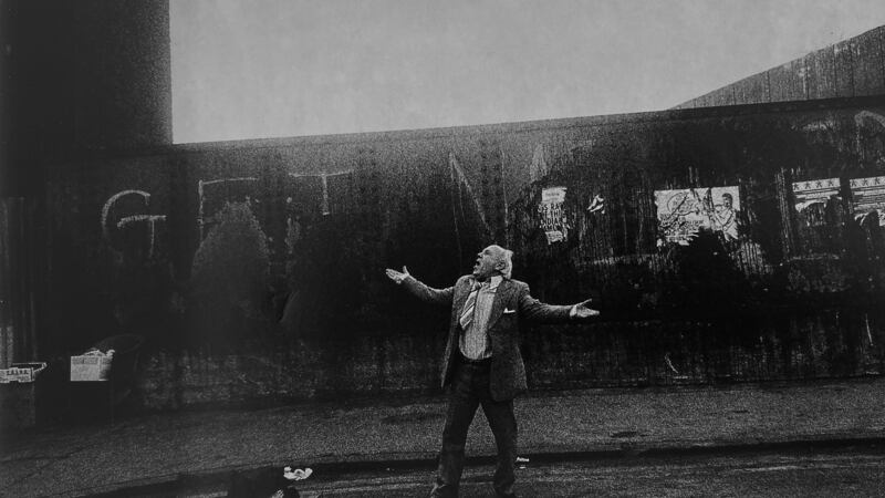 Man standing, arms outstretched, singingBrick Lane 1982. Photograph: Markéta LuskaÄ?ová