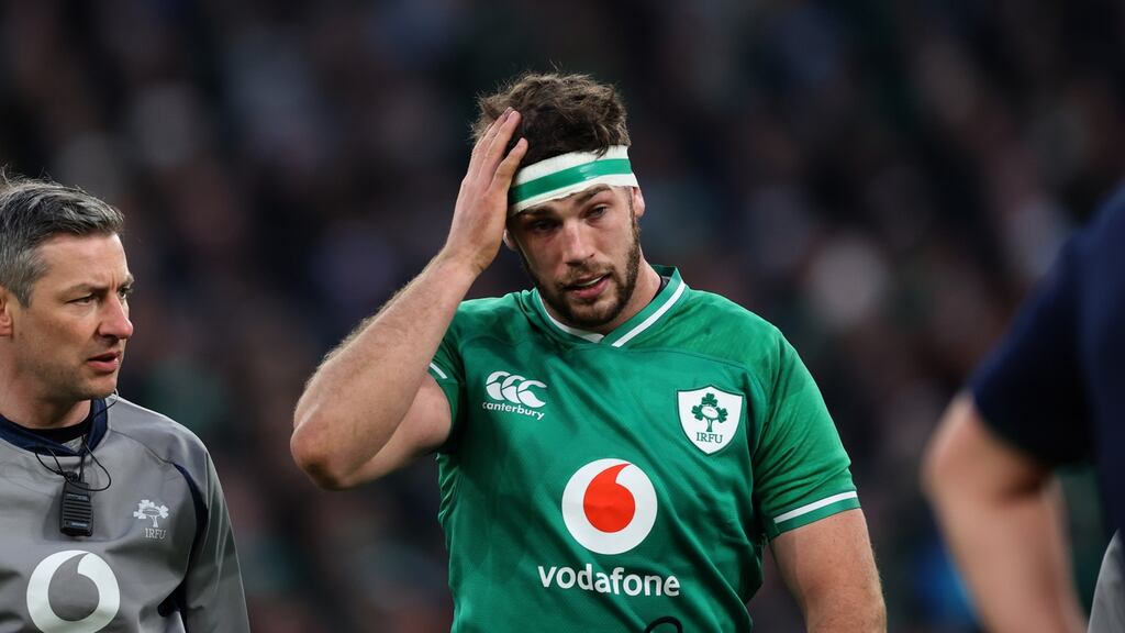 Caelan Doris leaves the field after suffering an early concussion on his home debut against Scotland at the Aviva Stadium. Photograph: Billy Stickland/Inpho