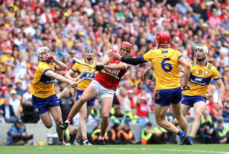 Clare's John Conlan and Adam Hogan look to close down Ciarán Joyce of Cork. Photograph: Bryan Keane/Inpho