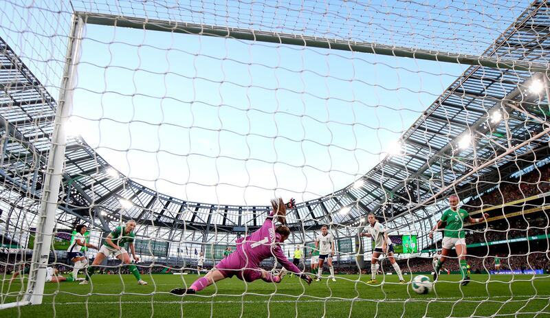 England’s Lauren James scores her side's first goal past Ireland goalkeeper Courtney Brosnan. Photograph: Ryan Byrne/Inpho