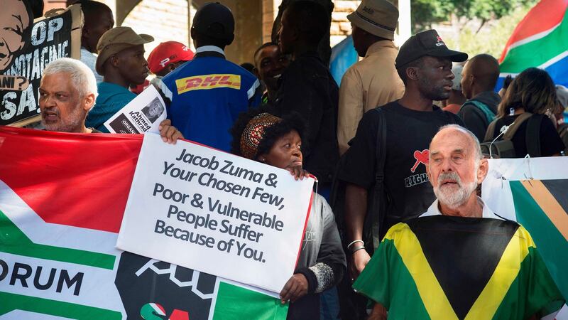 A woman holds a placard reading “Jacob Zuma & your chosen few, poor & vulnerable people suffer because of you” in Cape Town on April 6th. Photograph: Rodger Bosch/AFP/Getty Images