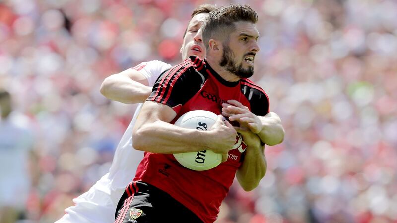 Down’s Connaire Harrison with Colm Cavanagh of Tyrone