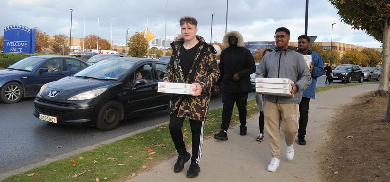 Krispy Kreme: customers carry boxes of doughnuts from the Blanchardstown store. Photograph: Aidan Crawley