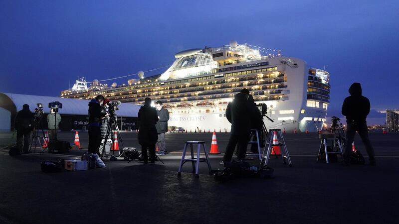 Members of the media work in front of the Diamond Princess cruise ship, docked in Yokohama, Japan. Photograph: Toru Hanai/Bloomberg