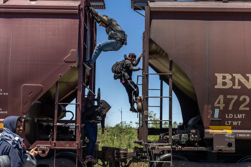 Venezuelan migrants hop on a freight train in Cuidad Juarez, Mexico, to make their way to the border. Photograph: Alejandro Cegarra/the New York Times