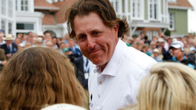Phil Mickelson celebrates with his family after his birdie putt on the 18th completing his round during day four of the 2013 Open Championship at Muirfield Golf Club, East Lothian. Photograph: Peter Byrne/PA Wire