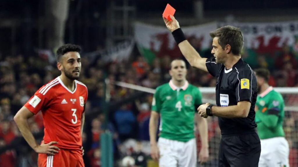 Wales defender Neil Taylor is shown a red card by Italian referee Nicola Rizzoli for his tackle on Seamus Coleman. Photograph: Getty Images