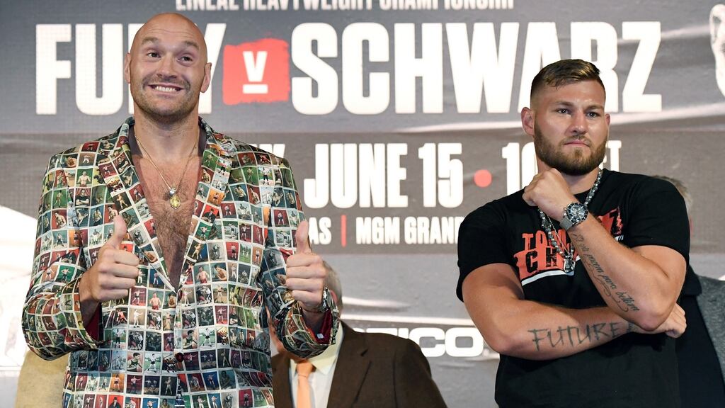 Tyson Fury and Tom Schwarz pose during a news conference at MGM Grand in Las Vegas ahead of their heavyweight bout. Photograph: Ethan Miller/Getty Images