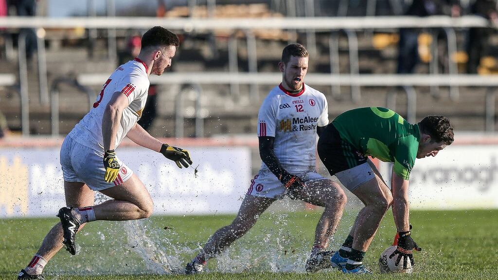 Queen’s Ryan Murray tries to escape the attentions of Tyrone’s Niall Sludden during his side’s heavy McKenna Cup defeat. Photograph: Inpho