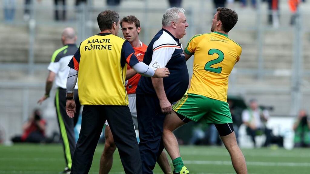 Armagh manager Paul Grimley has a word with Eamonn McGee of Donegal in the All-Ireland football championship quarter-final at Croke Park. Photograpf: Inpho.