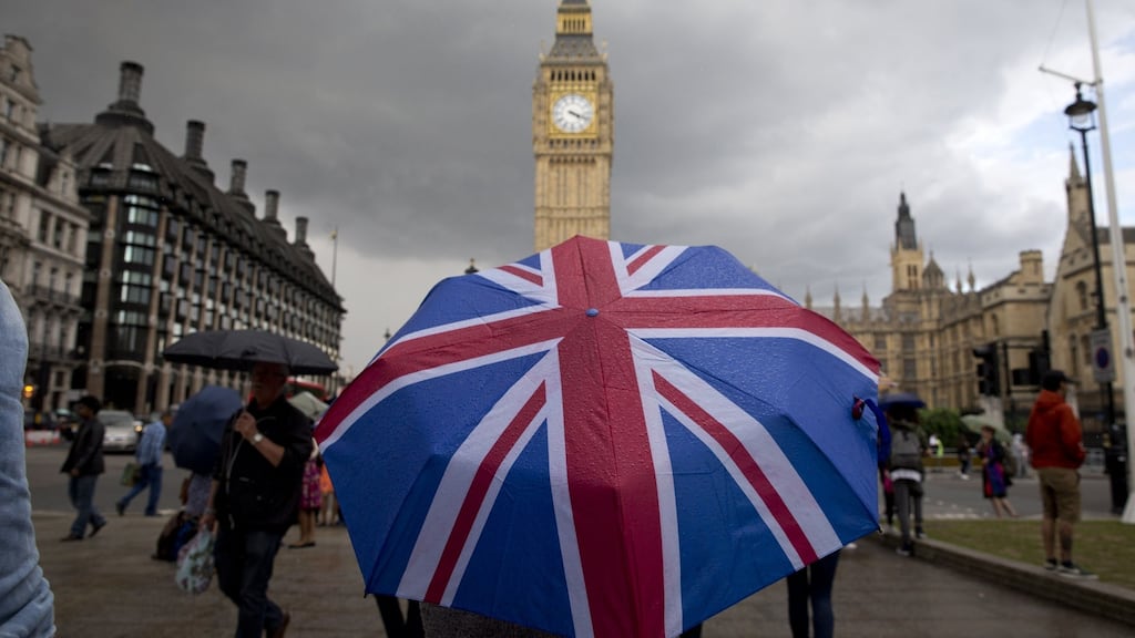 A pedestrian shelters from the rain beneath a Union Jack umbrella at the Houses of Parliament in London, following the pro-Brexit result of the UK’s referendum in June, 2016. Photograph: Justin Tallis/AFP/Getty Images