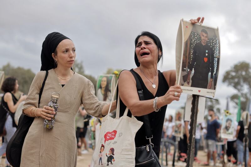 A woman is overcome during a gathering at the site of the Nova music festival near Kibbutz Reim, Israel, on the anniversary of the October 7th attacks. Photograph: Avishag Shaar-Yashuv/New York Times