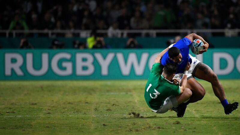 Ireland centre Robbie Henshaw  tackles Samoa wing Ed Fidow during the Rugby World Cup Pool A match at the Hakatanomori Stadium in Fukuoka. Photograph: Christophe Simon/AFP via Getty Images