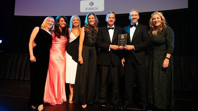 Joe Creegan, Head of Corporate Life & Pensions, Zurich Life, presents the HR Team of the Year award to the Three Ireland team.