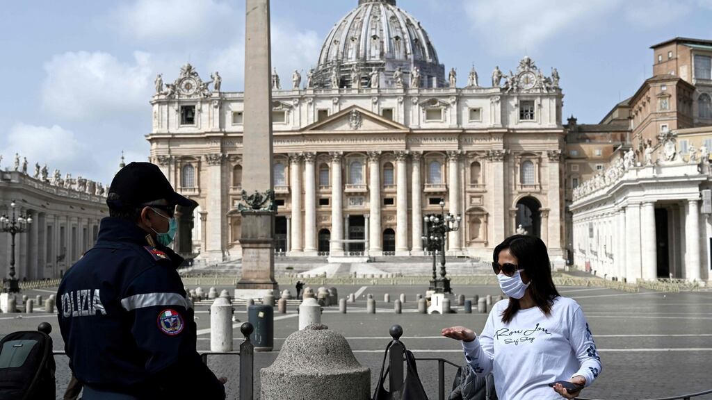 A policeman talks with a woman in front of an empty St Peter’s Square prior to Pope Francis’ livestreamed Angelus prayer on March 29th. Photograph: AFP