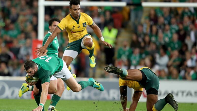 Ireland’s Robbie Henshaw is tackled by Will Genia and Marika Koroibete of Australia during the first Test at Suncorp Stadium in Brisbane. Photograph: Dan Sheridan/Inpho