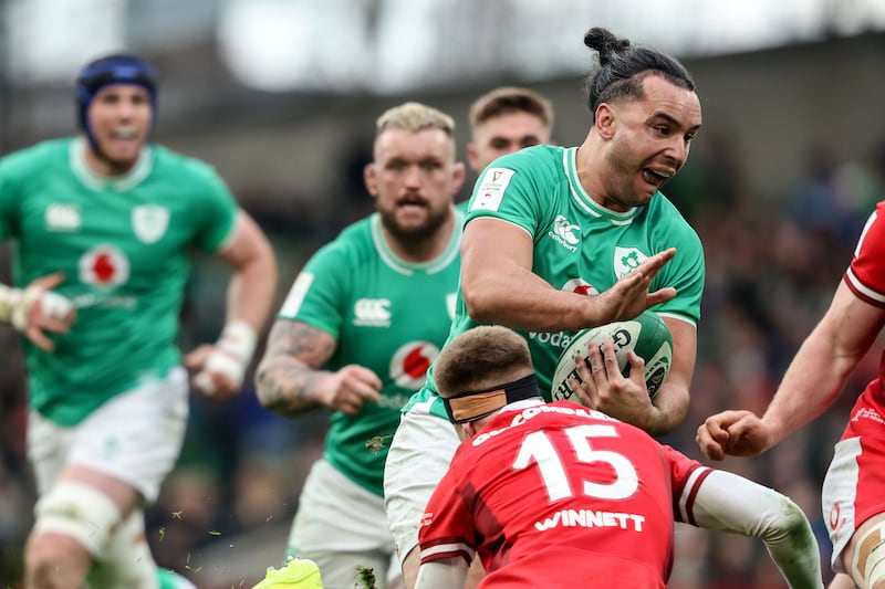 Ireland’s James Lowe with Cameron Winnett of Wales. Photograph: Dan Sheridan/Inpho
