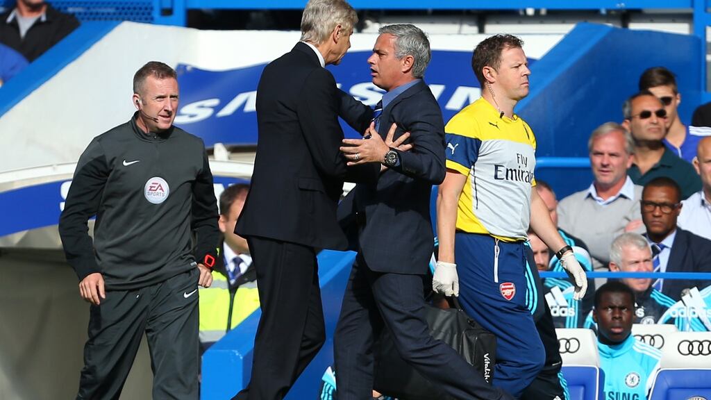 Arsene Wenger and Jose Mourinho scuffle on the sideline in 2014 when Arsenal played at Chelsea. Photograph: Getty Images