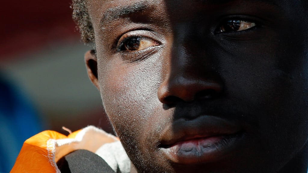 A migrant watches after disembarking from the Norwegian vessel Siem Pilot at Pozzallo’s harbour, Sicily, Italy, March 29th, 2016. Some 730 migrants who had been rescued in various operations in previous days and transferred to a larger ship arrived in Pozzallo today. Photograph: Antonio Parrinello/Reuters