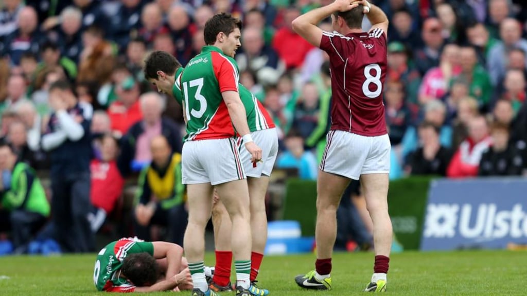 Mayo’s Alan Dillon lies injured following an off the ball incident with Galway’s Niall Coleman which resulted in a straight red card. Photograph: James Crombie/Inpho