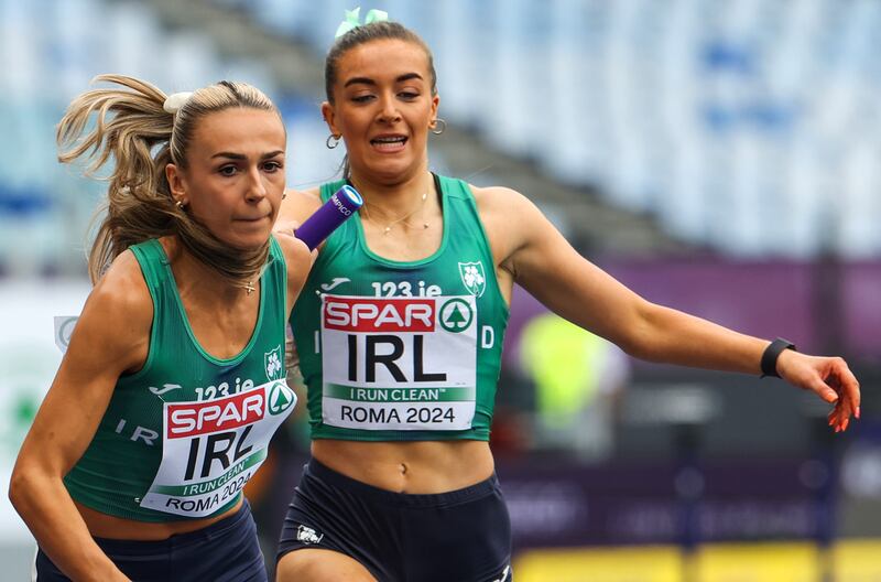 Lauren Cadden passes the baton to Sharlene Mawdsley. Photograph: Morgan Treacy/Inpho