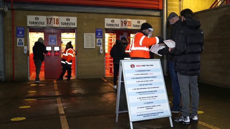 Stewards check documents and run temperature checks on fans. Photo: John Walton/PA Wire