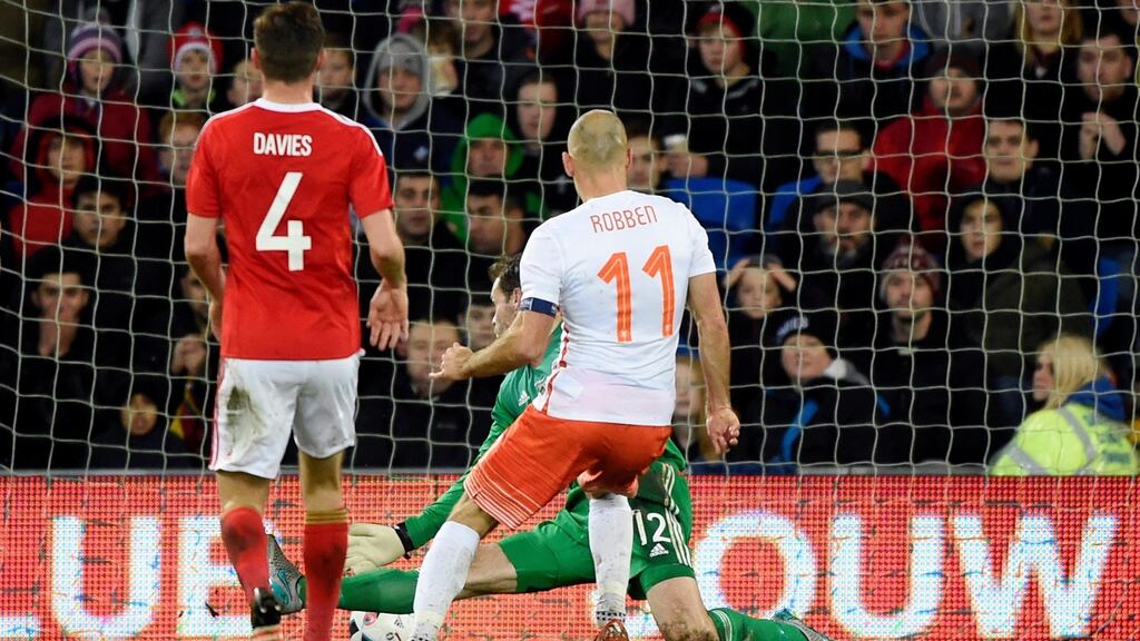 Holland’s Arjen Robben scores their third goal in Cardiff. Photograph: Rebecca Naden/Reuters