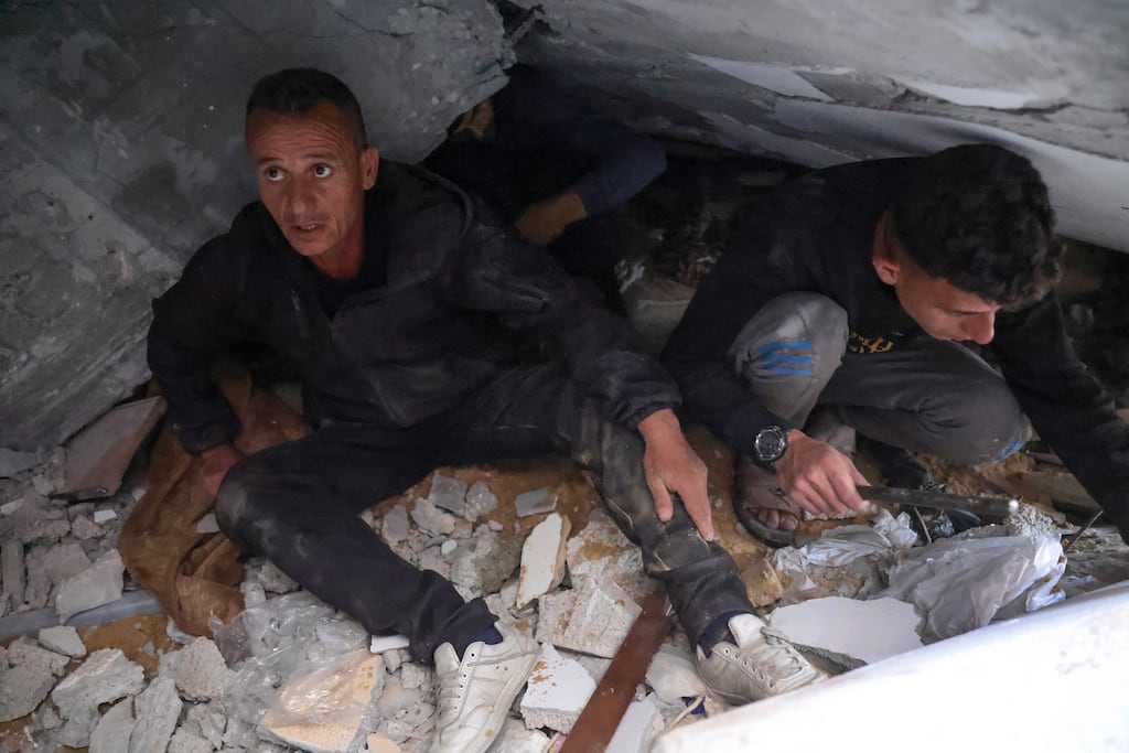 People search for victims stuck under rubble following an Israeli airstrike that hit the home of a Palestinian family in Jabaliya in the northern Gaza Strip. Photograph: Bashar Taleb/AFP/Getty
