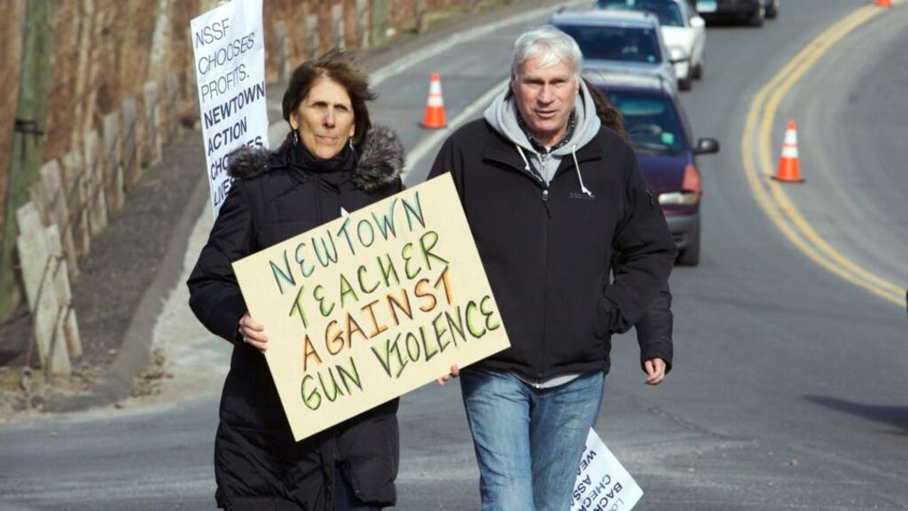 Lil Martenson, (
L
left) a teacher in Newtown, Connecticut,
teacher,
arrives to join
Newtown
residents of the town protesting outside the National Shooting Sports Foundation
in Newtown, Connecticut March 28, 2013
in Newtown. Photograph: Reuters
Residents began receiving robocalls from the NRA trying to enlist them in efforts to defeat new statewide gun control proposals, three months after a gunman killed 20 students and six adults at Sandy Hook elementary School in Newtown, Connecticut December 14, 2012. REUTERS/ Michelle McLoughlin (UNITED STATES - Tags: EDUCATION CRIME LAW)