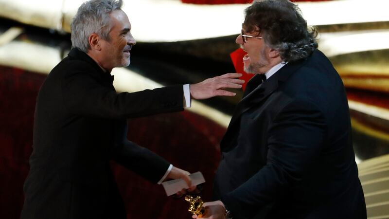 Alfonso Cuaron (left) accepts the Best Director award for ‘Roma’ from director Guillermo del Toro. Photograph: REUTERS/Mike Blake