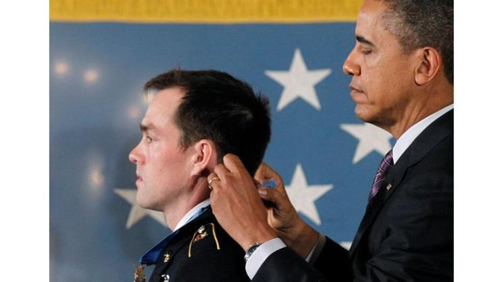 President Obama awards a Medal of Honor to Sergeant Clinton Romesha at the White House yesterday. Mr Obama is expected to announce the withdrawal of 34,000 troops from Afghanistan in his state of the union speech. Photograph: Jason Reed/Reuters
