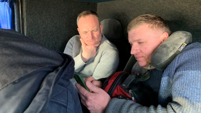 Construction worker Petro Hirnyy and welder Petro Antonyuk en route from Paris to Lviv to join the Ukrainian territorials against the Russians. They keep a close watch on their smartphones. Photograph: Lara Marlowe