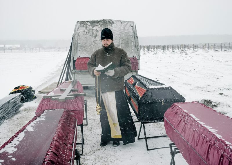 An Orthodox priest gives funeral rites for Wagner group mercenaries in February on the outskirts of Bakinskaya, a village in Russia’s Krasnodar region. Photograph: Nanna Heitmann/New York Times