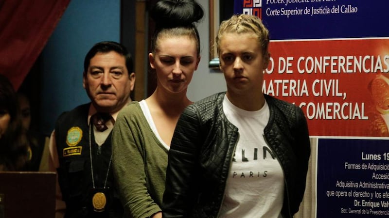 Melissa Reid (right) and Michaella McCollum Connolly arrested on suspicion of smuggling cocaine out of Peru, are escorted by police as they enter the Justice Court of Callao in August. Photograph: Mariana Bazo/Reuters