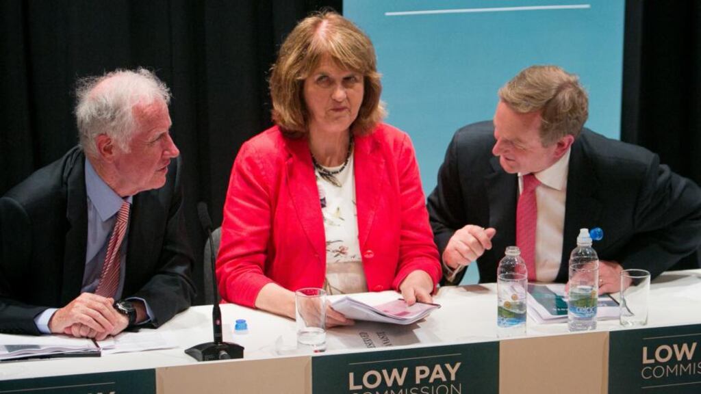 Chairman of the Low Pay Commission Donal de Buitléir, Tánaiste Joan Burton and Taoiseach Enda Kenny during the official launch of the commission’s report on the national minimum wage at Seán O’Casey Community Centre, East Wall, Dublin. Photograph: Gareth Chaney Collins