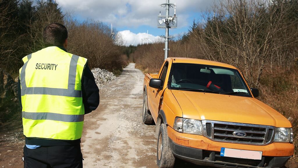 A security man at the entrance to the wind farm formerly owned by the Quinn Group, at Slieve Rushen, Co Cavan. Photograph: John McVitty