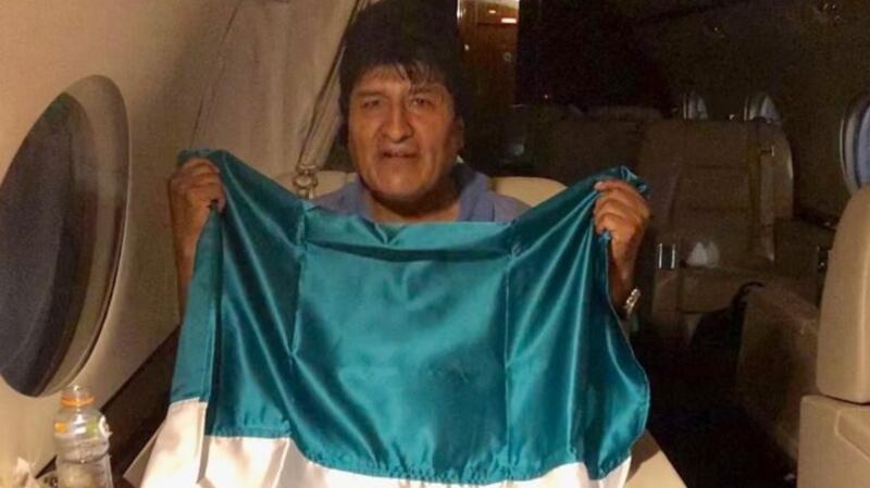 Former Bolivian president Evo Morales poses with a Mexican flag on a Mexican Air Force plane on Monday. Photograph: EPA/Mexican Foreign Ministry