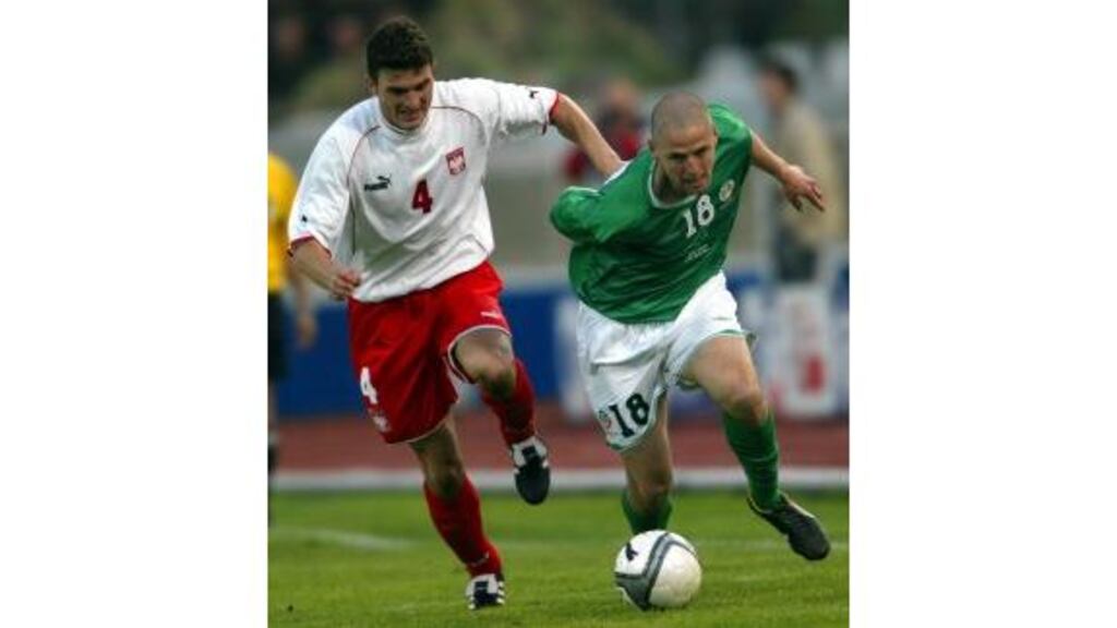 Michal Zewlakow of Poland races for the ball with Republic of Ireland?s Graham Barrett during yesterday?s friendly international at the Zawisza Stadium in Bydgoszcz, Poland.