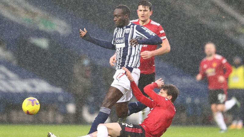 Victor Lindelof slides in to tackle Mbaye Diagne. Photo: Michael Steele/POOL/AFP via Getty Images