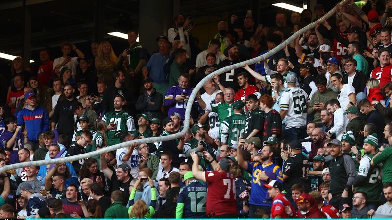 Fans create a beer snake with empty plastic glasses during the game at Tottenham Hotspur Stadium. Photograph: Clive Rose/Getty Images