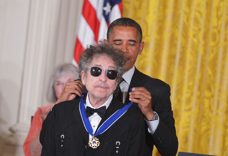 (FILES) This file photo taken on May 29, 2012 shows US President Barack Obama (R) presenting the Presidential Medal of Freedom to US musician Bob Dylan in the East Room of the White House in Washington.US songwriter Bob Dylan won the Nobel Literature Prize on October 13, 2016, the first songwriter to win the prestigious award and an announcement that surprised prize watchers. / AFP PHOTO / MANDEL NGANMANDEL NGAN/AFP/Getty Images