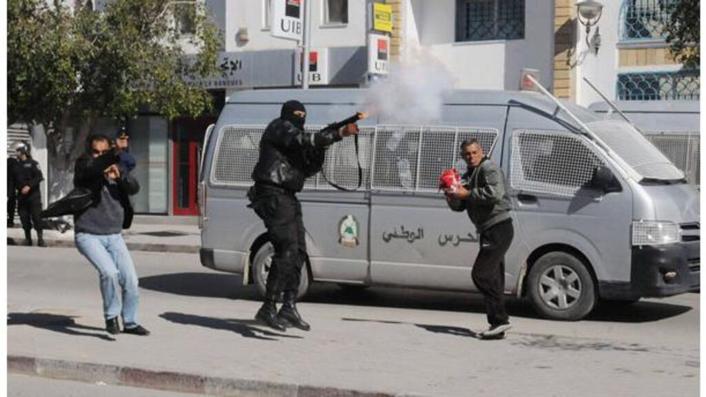 A police officer fires teargas to break up a protest during a demonstration in Gafsa yesterday. Thousands of Tunisians demonstrated outside the interior ministry headquarters. Photograph: Reuters/stringer