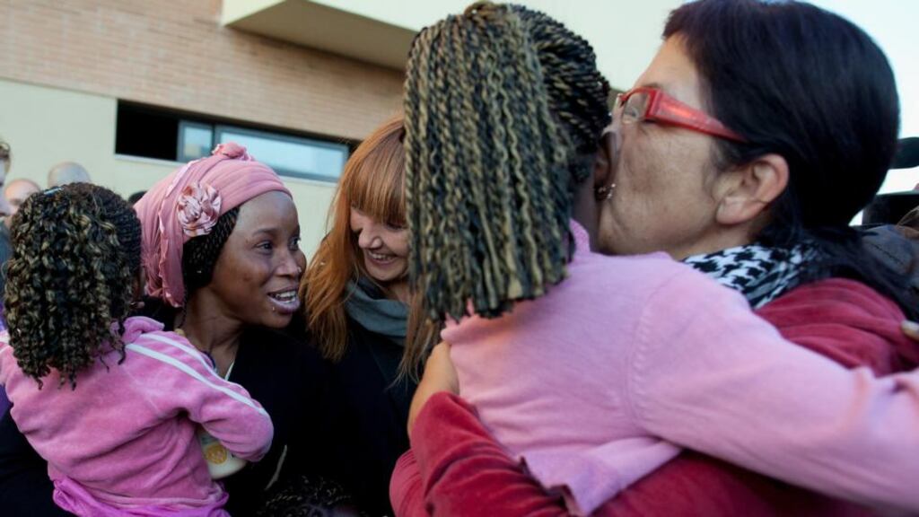 Activists congratulate Mariama Siall (29) and her daughters Ajafatu (two) and Kaliatu (eight) yesterday after hearing that the eviction of the block of flats occupied by the anti-evictions platform had been stopped. Photograph: Pablo Blazquez Dominguez/Getty Images