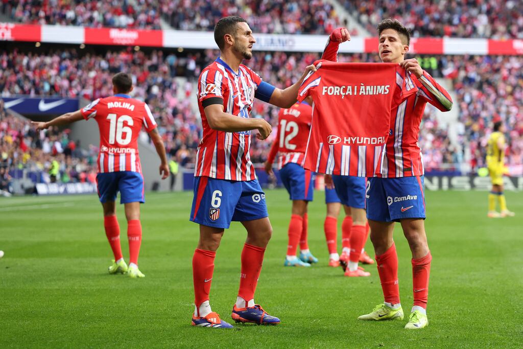 Atletico Madrid's Argentine forward Giuliano Simeone holds a jersey in support of the floods victims in Valencia. Photograph: Pierre-Philippe Marcou/AFP via Getty
