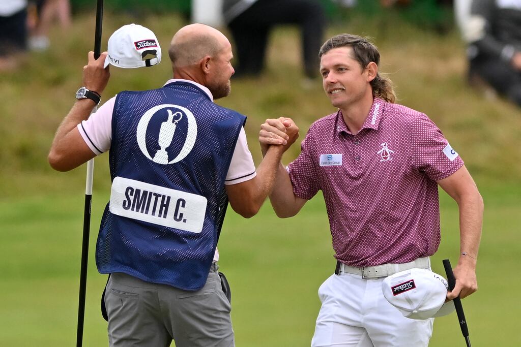 Australia's Cameron Smith celebrates with his caddie after holing his final putt to make a birdie on the 18th green. Photograph: Glyn Kirk/AFP via Getty